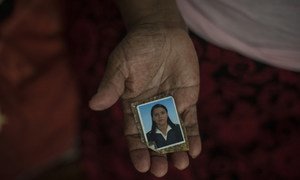 A 71-year-old Salvadorian refugee living in Mexico shows a picture of her daughter, who was murdered by a gang at the age of 27, before the family fled.