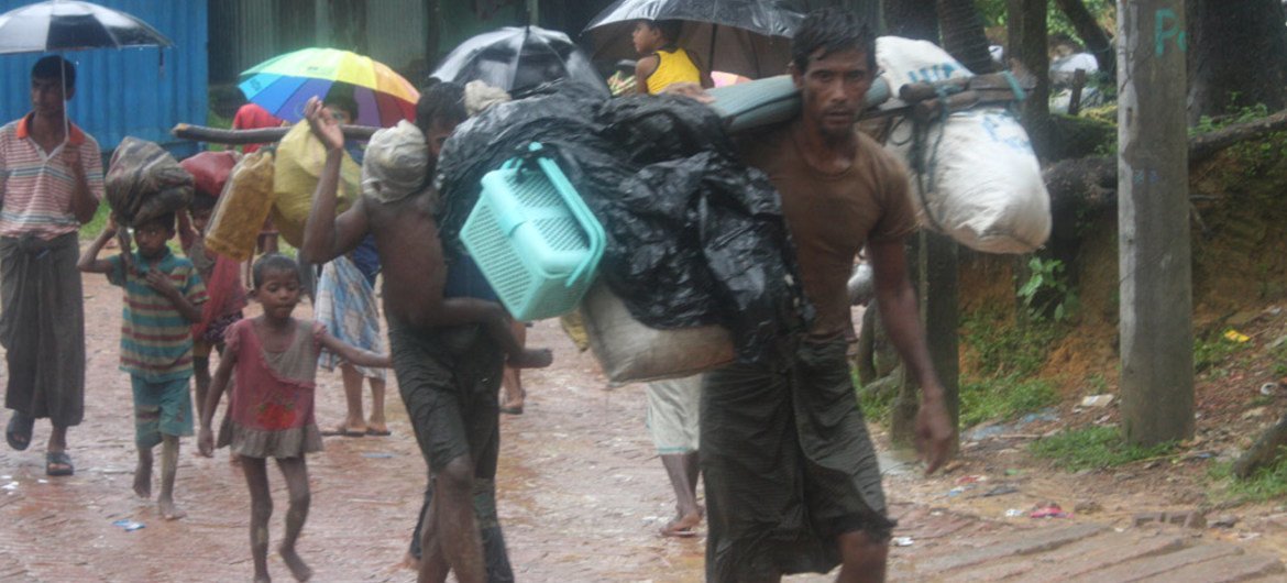 Rohingya refugees trudge through the rain and mud as they arrive at Kutupalong camp in Bangladesh after days on foot.