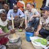 In Ethiopia, IFAD’s Gilbert Houngbo, WFP’s David Beasley and FAO’s José Graziano da Silva watch as a woman makes a nutritious porridge at a health centre in Tigray region.