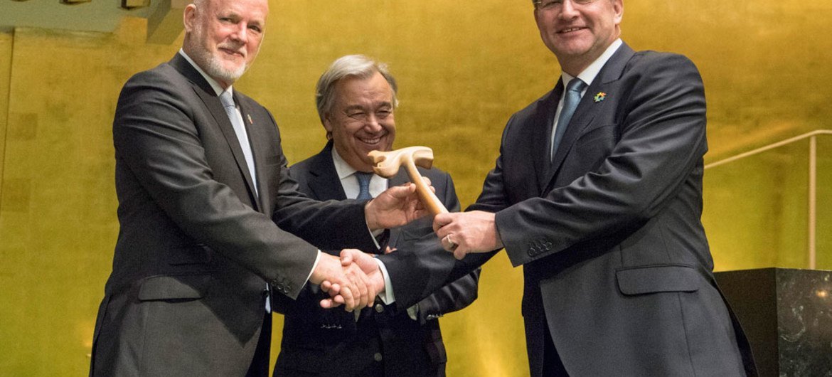 Peter Thomson (left), President of the seventy-first session of the General Assembly, passes the gavel on to Miroslav Lajcák (right), President of the seventy-second session, as Secretary-General António Guterres looks on.