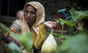 Woman in Cox's Bazar, Bangladesh, receives food from UN and aid partners after fleeing Myanmar.