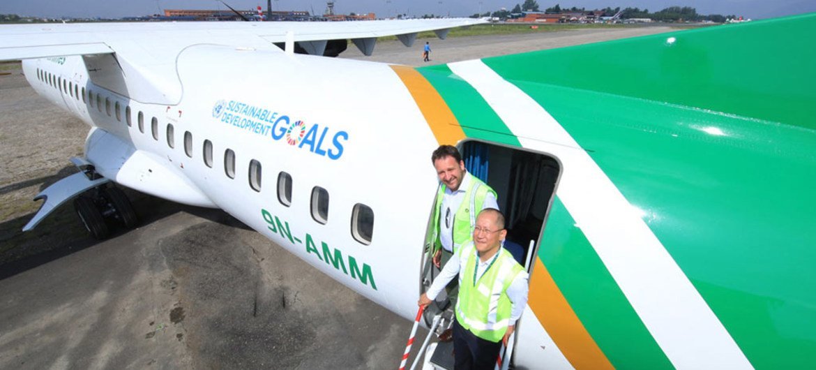 UNDP Country Director for Nepal Renaud Meyer (left) and Yeti Airlines CEO Umesh Chandra Rai aboard an aircraft bearing the UN SDGs branding at Kathmandu airport.