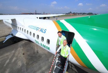 UNDP Country Director for Nepal Renaud Meyer (left) and Yeti Airlines CEO Umesh Chandra Rai aboard an aircraft bearing the UN SDGs branding at Kathmandu airport.