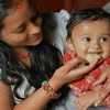 尼泊尔一位母亲正在给孩子喂健康的补充食品。 图片来源：2013 Valerie Caldas, Courtesy of Photoshare