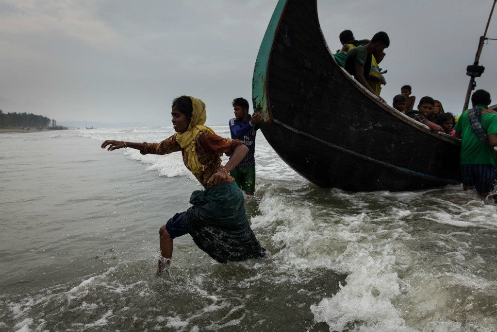 Rohingya refugees walk ashore at Shamlapur beach in Cox's Bazar district in Bangladesh, after crossing the Bay of Bengal. (File)