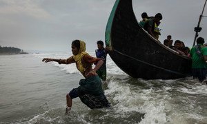 Rohingya refugees walk ashore at Shamlapur beach in Cox's Bazar district in Bangladesh, after crossing the Bay of Bengal in September 2017.