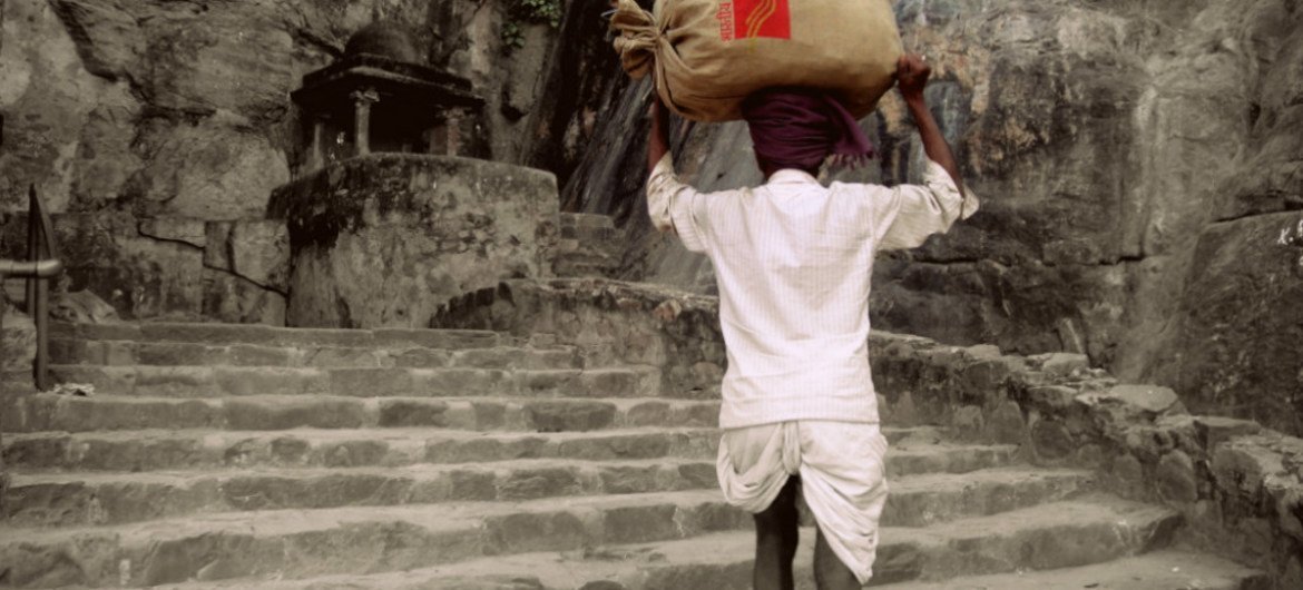 A rural postman of India delivers letters in Rajhastan, India.