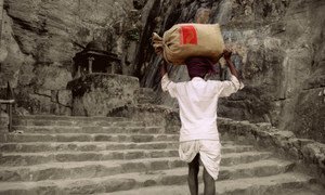 A rural postman of India delivers letters in Rajhastan, India.