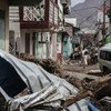 A woman walks in the street of Roseau, capital of Dominica, which has struggled to overcome the severe impact of two category 5 hurricanes which tore through the region in September 2017.