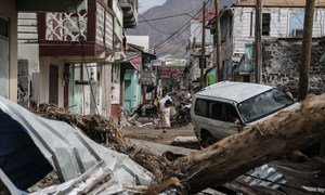 A woman walks in the street of Roseau, capital of Dominica, which has struggled to overcome the severe impact of two category 5 hurricanes which tore through the region in September 2017.