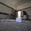 A school guard walks through a school in Yemen's capital Sana'a that was heavily damaged during an air strike on the building next to it. (File)