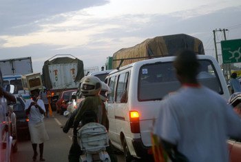Street vendors work between vehicles stuck in traffic in Tema, Ghana.
