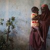 Dada, 15, holds her 18-month-old daughter Husseina where shes live in a host community in Maiduguri, Borno State, northeast Nigeria.