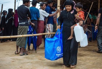 A woman collects hygiene kits for her family in Cox’s Bazar temporary settlement camps.