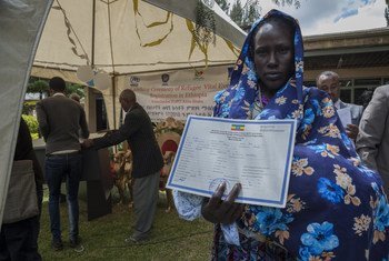 A South Sudanese refugee stands with her 18 day-old son, who was among the first refugee children to receive a birth certificate in Ethiopia.