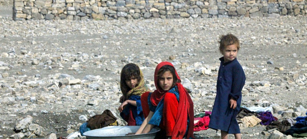 Young girls washing clothes near a small stream at the Gulan camp in the south-eastern Afghan province of Khost. Water scarcity for domestic use is one of the major issues camp residents face. Photo UNAMA/Sayed Muhammad Shah (file)