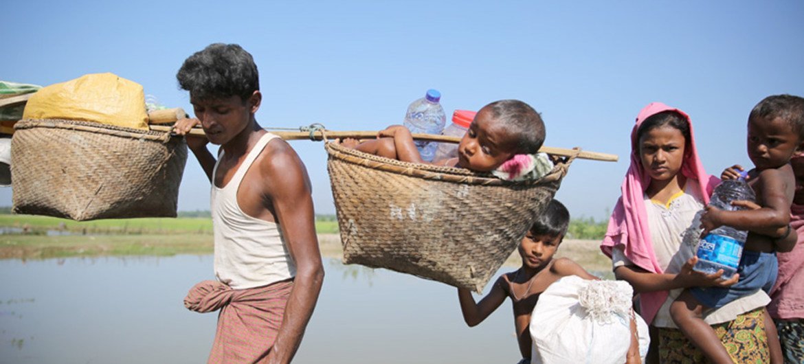 Rohingya refugees cross into Bangladesh from Myanmar at the Anjumanpara border crossing point.