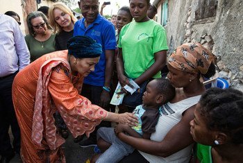 Deputy Secretary-General Amina Mohammed (foreground left) and UN Special Envoy for Haiti Josette Sheeran (rear left) with Haitian families affected by cholera.