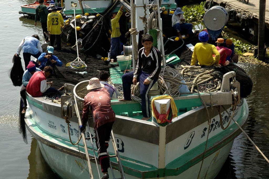 Migrants from Myanmar working on a Thai boat in the Mahachai port.