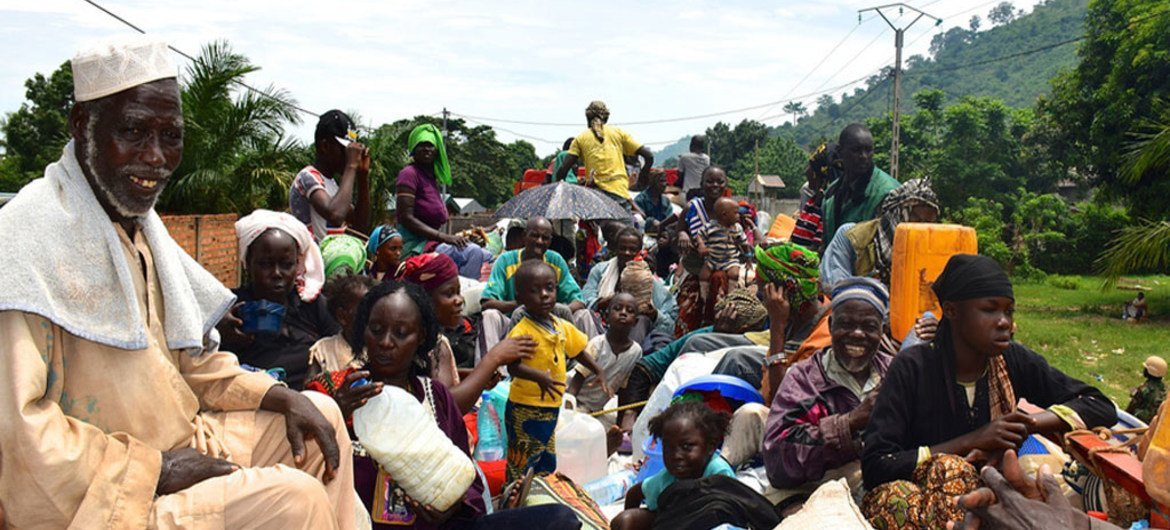 Civilians on board trucks during a previous IOM relocation of internally displaced persons in the Central African Republic.