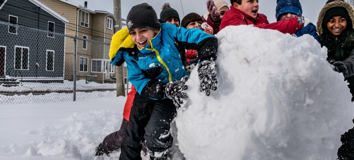 Eleven-year-old Basel Alrashdan (light blue jacket), who is from a Syrian refugee family resettled in Canada, plays with his friends from his school, Charlottetown on Prince Edward Island. UNICEF/Gilbertson VII Photo