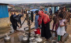 Women draw water from a pump installed by a non-governmental organization in the Kutupalong makeshift settlement for Rohingya refugees in Ukhiya, a sub-district of Cox's Bazar in Bangladesh.