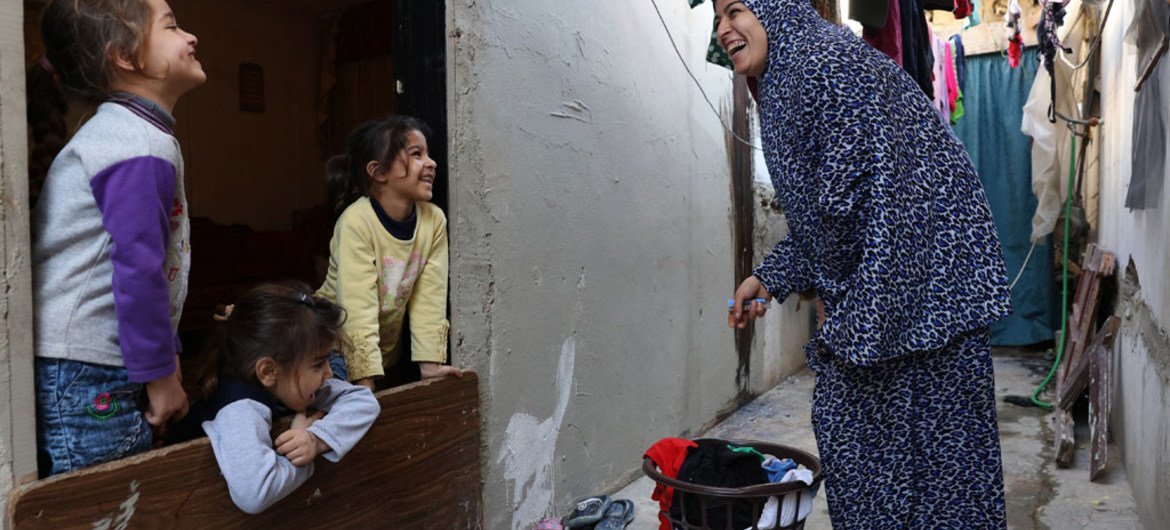 Zainab Al Ali laughs with her kids, Razan Abdallah, Rahaf Abdallah, and Rawan Abdallah in their home in Tripoli, Lebanon. March 2016.