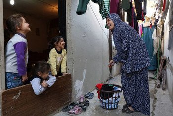 Zainab Al Ali laughs with her kids, Razan Abdallah, Rahaf Abdallah, and Rawan Abdallah in their home in Tripoli, Lebanon. March 2016.