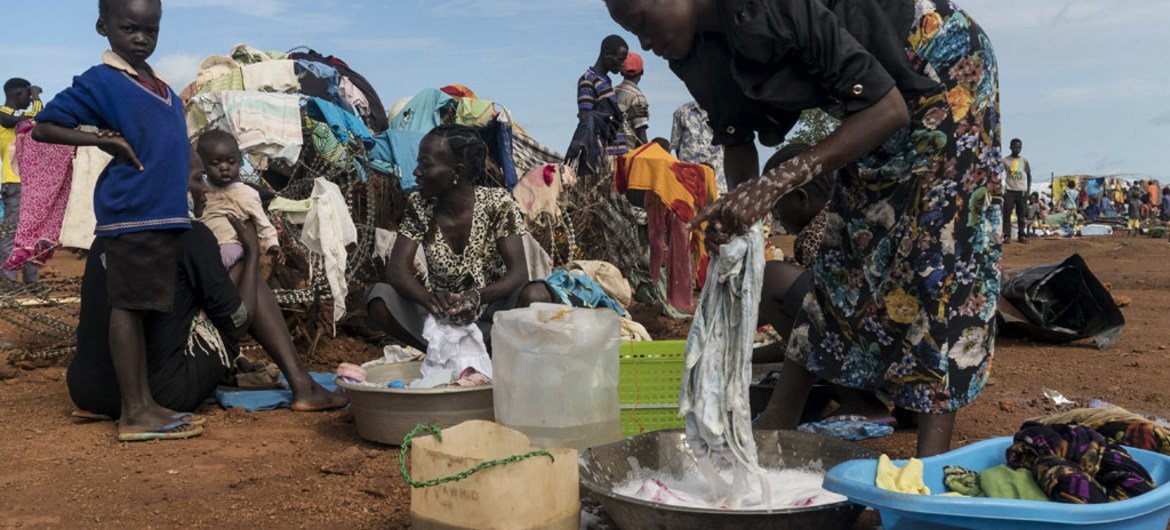 Ronda (right), who has been living in the open, washes clothes in the UN Protection of Civilians Site that houses thousands of displaced people in Wau, South Sudan.