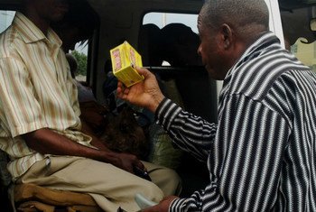 A man sells drugs for treating intestinal worm infection to passengers at a car park in Ikot Ekpene, Akwa Ibom State, Southern Nigeria.