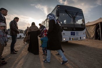 Migrants boarding the bus headed towards the processing center in Amman, Jordan.
