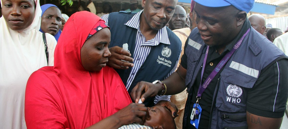 A WHO official vaccinates a child against cholera during an OCV campaign in Borno state, north-eastern Nigeria.