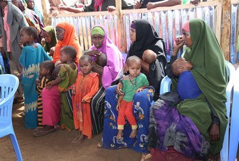 Mothers and their children in a queue waiting to receive measles vaccinations as part of a UNICEF-supported immunization campaign at the Beerta Muuri camp for internally displaced persons in Baidoa, Somalia (file).