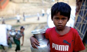 A seven-year-old Rohingya girl carries a pot of water to her family’s makeshift shelter after filling it at a hand operated water pump at the Bormapara makeshift settlement in Ukhia, Cox’s Bazar, Bangladesh.