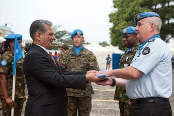 SRSG of UNMIL Farid Zarif handling flags to the UNMIL peacekeepers on the farewell ceremony in Monrovia Liberia...