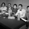Some of the officers of the UN Radio Service in 1960 with signs indicating the languages in which they broadcast.