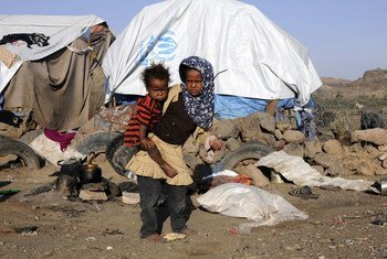在定居点的帐篷外面，8岁的Rahaf Ali Bedaish带着她2岁的弟弟Ahmed。 自也门冲突2015年开始以来，他们一直在塔伊兹省处于流离失所状态。