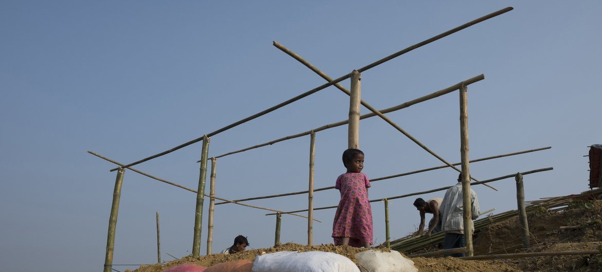 A three-year-old Rohingya refugee stands against the bamboo frame of the shelter her family is constructing in Balukhali makeshift settlement, Cox’s Bazar, Bangladesh.