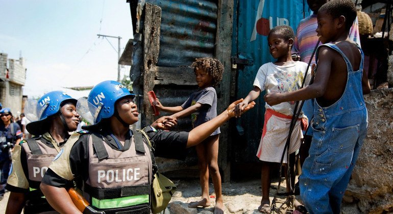 Female police officers from Nigeria engaging with local children as they patrol the slum of Martissant in Port au Prince as part of their duties with the UN peacekeeping mission in Haiti in 2009.
