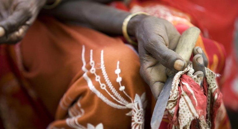 At a community meeting in Kabele Village, Ethiopia, former FGM practitioner Boko Mohammed holds the tool she used to use while performing the procedure. 