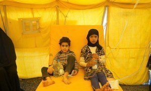 Two unrelated children, one eight and the other ten, share a bed at a cholera treatment centre in Sana'a, Yemen, due to lack of resources.