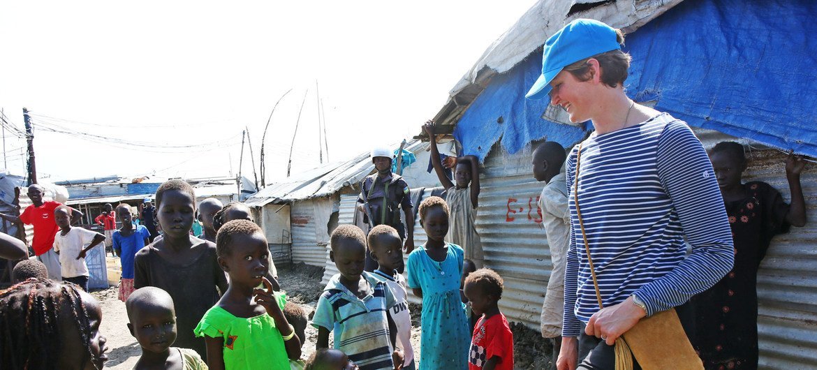 Caption: Lt. Col. Katie Hislop, the first female contingent commander to serve with the UN Mission in South Sudan (UNMISS), greets children in the Bentiu Protection of Civilians site. 