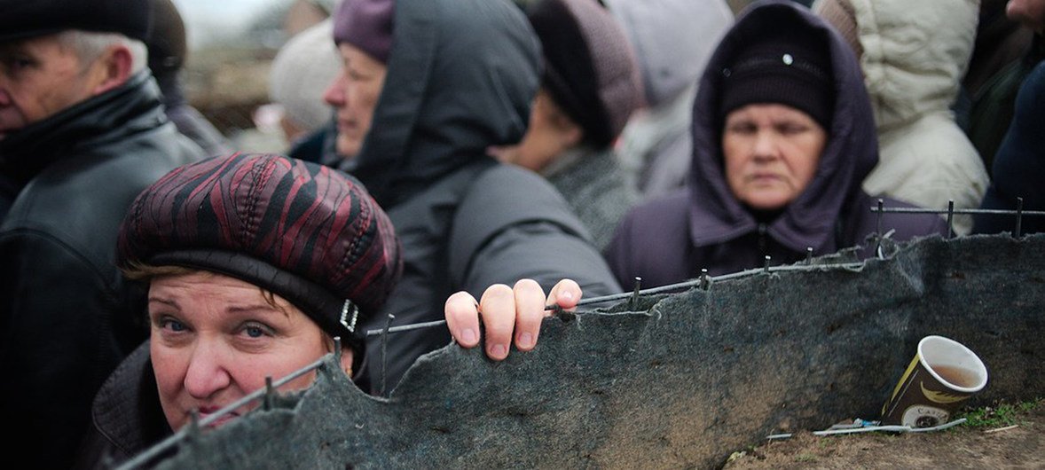 People crossing the 'contact line' at Stanytsia Luhanska which is the only one operational entry/exit checkpoint in Luhansk province, Ukraine.