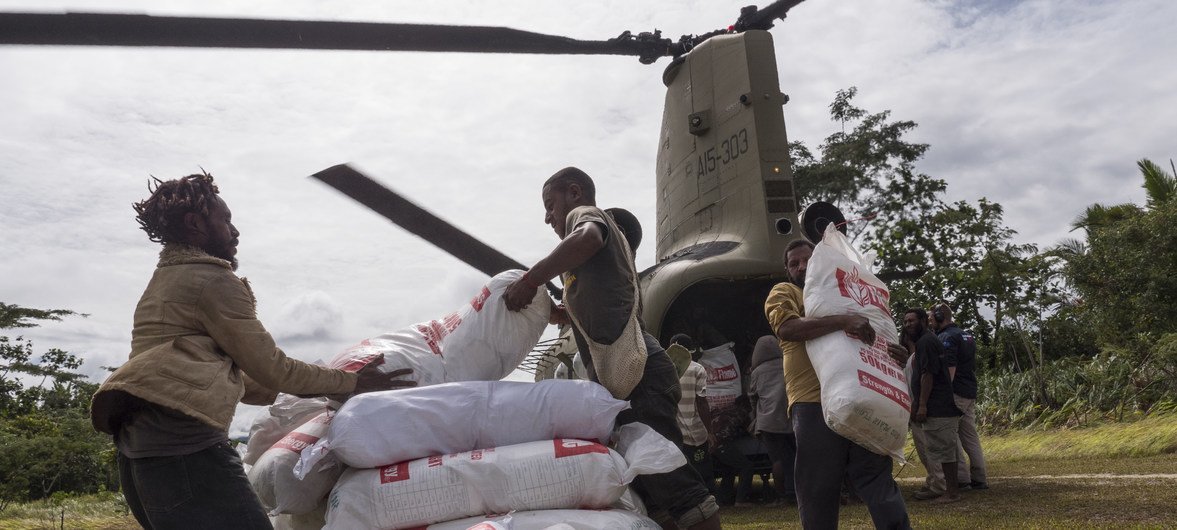 Relief workers unload food aid flown in by helicopter for people affected by the 7.5 magnitude earthquake which struck Papua New Guinea in February 2018.