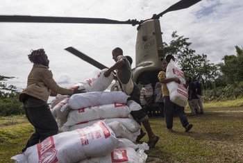 Relief workers unload food aid flown in by helicopter for people affected by the 7.5 magnitude earthquake which struck Papua New Guinea in February 2018.