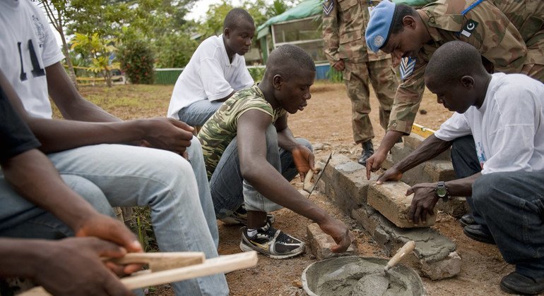 Pakistani peacekeepers teach young Liberians to lay bricks as part of a job training programme offered by the contingent in Tubmanburg. 