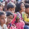 Villagers watch folk artists perform a street play on the issue of child marriage and the evils of it, at the village square, in Jamua block of the Giridih district of Jharkhand state, India.