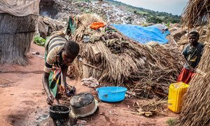 Woman cooking in Katanika IDP site, where more than 6,000 families have taken refuge fleeing growing interethnic violence in the area. The site is located a few kilometers from Kalemie, the capital of Tanganyika province in the south-east of the Democratic Republic of the Congo.