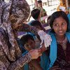 A health worker inoculates a Rohingya girl in the Unchiprang makeshift refugee camp in Bangladesh's Cox's Bazar district during a UNICEF-supported measles vaccination campaign.