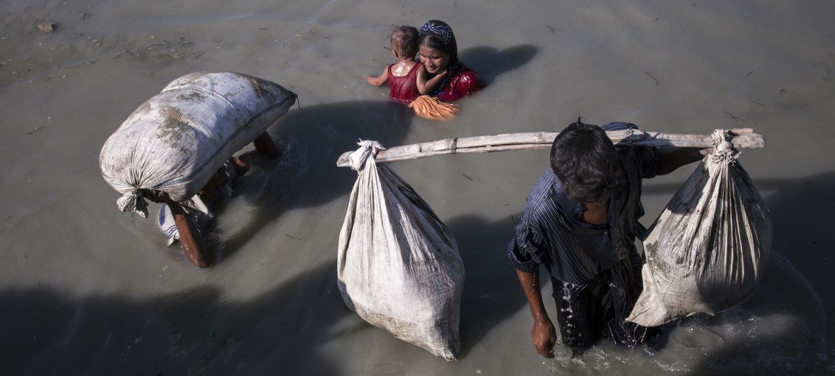 A group of Rohingya refugees including women and small children cross into Bangladesh at Palong Khali in Cox’s Bazar district.